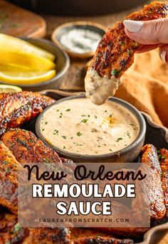 someone dipping sauce into some chicken wings with the words new orleans remoulade sauce