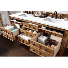 a bathroom vanity with two sinks and drawers underneath the sink is made out of wood