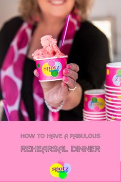 a woman holding up a pink cup filled with ice cream