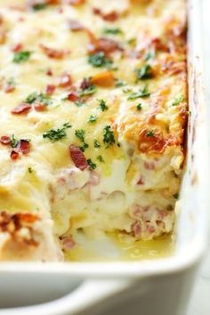 a casserole dish with ham, cheese and bacon in it on a white plate