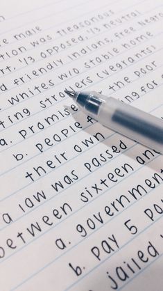 a pen sitting on top of a paper with words written in english and german language