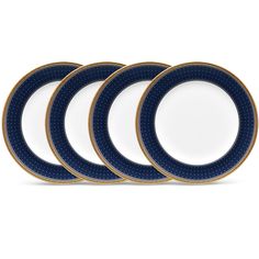 four blue and white plates sitting next to each other