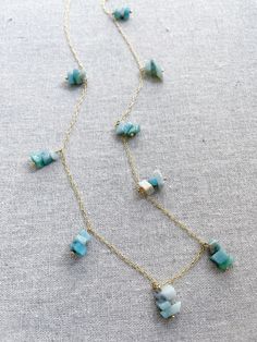 A gold necklace featuring groups of aquamarine stones. The aquamarine stone is used in holistic healing and crystal therapy. Spiritually, aquamarine is associated with trusting and letting go. In ancient times, aquamarine was believed to be the treasure of mermaids. Sailors used the stone as a talisman to bring good luck on the open waters. The gem was used as a symbol of protection and fearlessness too. Aquamarine 14k plated gold chain 30” long Shipping information Chakra Necklace, Crystal Therapy, Aquamarine Stone, Sterling Silver Hoop Earrings, Pink Quartz, Sterling Silver Hoops, Quartz Necklace, Love Yourself, Silver Hoop Earrings