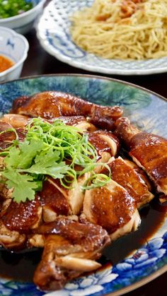 several plates of food on a table with chopsticks, sauce and noodles in them