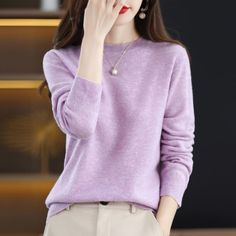 Elegant 100% Pure Cashmere Sweater Elevate your wardrobe with this luxurious 100% pure cashmere sweater. Expertly crafted from the finest cashmere blend, this pullover promises unparalleled softness and warmth, making it a must-have for chilly seasons. The rich mustard hue exudes sophistication, seamlessly blending style with comfort. Its classic round neckline is accentuated with a delicate silver pendant, adding a touch of elegance to its minimalist design. Paired with pearl earrings, this swe Heather Winter Sweater For Layering, Elegant Purple Sweater For Winter, Elegant Purple Sweater For Fall, Long Sleeve Cashmere Sweater With Soft Texture, Winter Heather Crew Neck Sweater, Elegant Soft Texture Winter Tops, Elegant Purple Sweater For Spring, Elegant Spring Purple Sweater, Classic Long Sleeve Plain Sweater