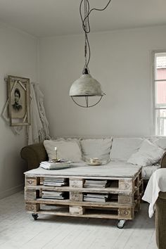 a living room filled with lots of furniture and decor on top of wooden pallets