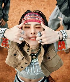 a woman with her hands on her face and two other people around her, all wearing bracelets