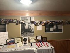 a table topped with pictures and plaques covered in photos