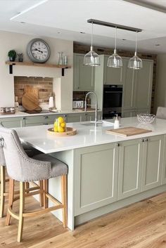 a large kitchen with an island and bar stools