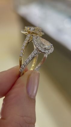 a person holding a diamond ring in their hand