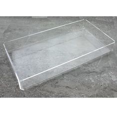 a clear plastic tray sitting on the ground