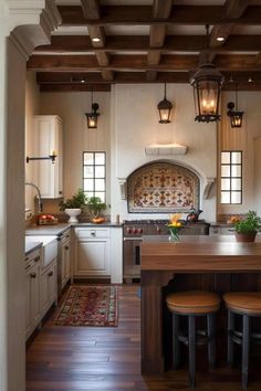 a large kitchen with wooden floors and white cabinets, along with an island in the middle