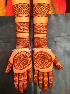 two hands with henna designs on them