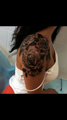 a woman with a black rose tattoo on her shoulder