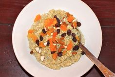 a white plate topped with oatmeal and raisins