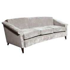 a gray couch with three seats on it's legs and one arm facing the camera