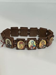 Hand-made prayer bracelet. Pray to your favorite saint and keep them close at all times. It consists of small icons  mounted on wooden slabs, which are separated by wooden beads and strung onto an elastic sized wristband.  Made of elastic cord, to apply on every wrist it is made of high quality wooden the icons are printed and laminated. Stretches. I wear mine everyday so I can have my prayers close to me.  This is an Orthodox prayer bracelet, say the Jesus prayer as you scroll by each icon.  Th Traditional Wooden Bracelets As A Gift, Traditional Wooden Bracelet As Gift, The Jesus Prayer, Souvenir Ideas, Icon Images, Orthodox Prayers, Christian Bracelets, Small Icons, Prayer Bracelet