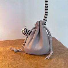 This beautiful leather drawstring pouch bag is so soft and supple . Carry your keys, lipstick and money all in this larger sized pouch. Drawstring loops slip over wrist. This large sized pouch bag is nice to take along day or night. Color - Grey Pouch size approx -6 1/2" H X 5 1/2" W Pull draw strings to close at top. Back to shop - http://www.etsy.com/shop/shirlbcreationstoo Read Customer Reviews from Shirlbcreationstoo customers here: http://www.etsy.com/people/oneredindian/feedbackHandcrafted Leather Medicine Pouch, Medicine Pouch, Large Pouch, Dice Bag, Coin Bag, Drawstring Pouch, Leather Gifts, Leather Pouch, Pouch Bag