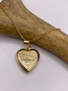 Vintage tiny mini heart locket  9k Gold filled Engraved  This tiny treasure has about a half inch photo space, just the locket without the bale.  Does not tarnish or change color.  on a gold 925 chain 16, 18, 20 or 24 inch  Lovely etched design Can hold tiny sized photo. Laminate photo before inserting for longevity  Ships on a gold 925 sterling silver chain  Thank you for supporting a small veteran owned business! All jewelry is shipped free within the US in a stylish gift box  PLEASE NOTE If w Engraved Flower, Gold Locket, Tiny Treasures, Photo Memories, Mini Heart, Heart Locket, 925 Sterling Silver Chain, Locket Necklace, Stylish Gifts