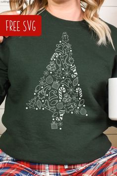 a woman wearing a green christmas tree sweatshirt with the words free svg on it