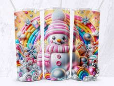 two tumblers with snowmen and rainbows on the side, one has a pink hat