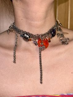 This unique multilayered necklace combines an eclectic mix of materials to create a statement piece that is both bold and stylish. With a total length of 33cm and an additional 12cm extender, this necklace features an array of glass beads, Czech beads, natural shell and horn elements, and stainless steel chains. The intricate design and diverse materials make it a standout accessory, perfect for adding a touch of edge to any outfit. Whether for a special event or everyday wear, this necklace is Unique Metal Necklace With Dangling Beads, Handmade Multi-strand Chain Necklace For Party, Unique Silver Multi-strand Beaded Necklaces, Unique Multi-strand Necklace For Parties, Unique Multicolor Necklaces, Multi-strand Glass Necklaces For Party, Colorful Beaded Dangle Necklaces, Unique Beaded Necklaces With Dangling Beads For Party, Unique Necklaces With Dangling Beads