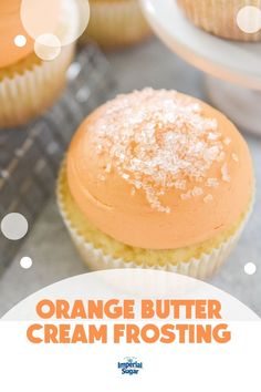 orange butter cream frosting on top of cupcakes