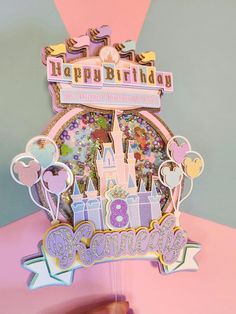 a happy birthday card with a castle and balloons on the top, surrounded by other decorations