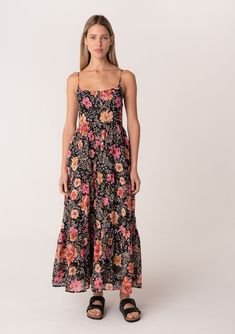 A cotton sleeveless spring maxi dress in a black and pink floral print. Floral print Relaxed, flowy fit Sleeveless Maxi length Tiered skirt Scooped neckline Half-smocked elastic bodice at the back Self-covered button front Adjustable spaghetti straps Side pockets Lined Flowy bohemian maxi dress This ultra-feminine floral print dress is perfect for any occasion, from a fun day out to a special event. It features adjustable spaghetti straps and a scooped neckline, making it easy to customize your Black Floral Print Maxi Dress For Summer, Flowy Sleeveless Maxi Dress With Smocked Bodice, Black Summer Maxi Dress With Smocked Back, Floral Maxi Sundress For Daywear, Black Sleeveless Maxi Dress With Smocked Back, Floral Sundress Maxi For Daywear, Black Maxi Dress With Smocked Back For Summer, Floral Sundress Maxi Length For Daywear, Maxi Length Floral Sundress For Daywear