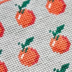 a cross stitch pattern with oranges on it