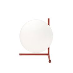 a white plate sitting on top of a metal stand with a red frame around it