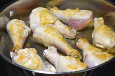 raw chicken in a pan cooking on the stove