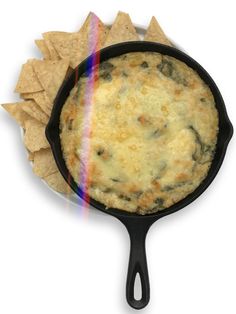 tortilla chips in a cast iron skillet with rainbow light coming from it