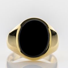 A retro gold ring, inspired by classical 1950s and 1960s gentlemens' jewelry, using solid yellow gold adorned with an onyx. Metal 14k / 0.585 gold Gemstones 1 onyx 15 x 13mm Measurements Head 17.8mm Shank 4.7mm Ring size 10.5 US / 63 EU Weight 7.5g Condition New General Information All items come with certificate of authenticity, gemstones have been tested at our lab if not otherwise indicated. Pendants are shown with chain for decorational reasons, please note that they do not come with a chain Classic Onyx Signet Ring With Polished Finish, Classic Black Signet Ring With Polished Edges, Classic Black Signet Ring For Formal Occasions, Classic Black Onyx Signet Ring, Black Oval Signet Ring For Formal Occasion, Classic Black 14k Gold Signet Ring, Classic Yellow Gold Onyx Rings, Formal Black Oval Signet Ring, Gold Onyx Signet Ring For Formal Occasions