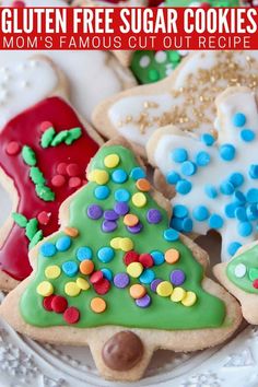 a plate full of decorated cookies with the words gluten free sugar cookies mom's famous cut out recipe