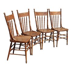 four wooden chairs sitting next to each other