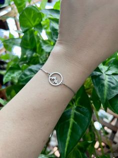 This Dainty Mountain Bracelet is the perfect addition to any nature lover's jewelry collection.  It's beautiful on its own, but also makes a great layering piece. Created with a 15 x 19 mm dainty round stainless steel charm with a mountain range cut out and attached to an adjustable bracelet with slider bead and two ball ends. Choose from rhodium plated chain or gold plated.  All jewelry comes ready to gift in a 100% recycled kraft paper box with eco-fiber filling and an elastic ribbon. Check ou Mountain Bracelet, Cottagecore Gifts, Celestial Gifts, Lover Jewelry, Space Jewelry, Elastic Ribbon, Bracelet Minimalist, Knuckle Rings, Boho Fall