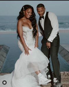 a bride and groom standing next to each other