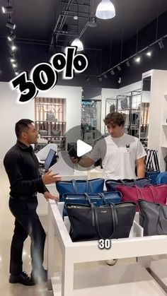 two men standing in front of a table with bags on it and the words 30 % off