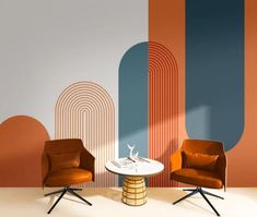 two chairs and a table in front of a wall with an abstract design on it