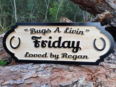 a sign that says bugs a livin'friday loved by reagan on the side of a tree