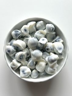 a white bowl filled with blue and white food