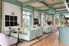 a living room filled with furniture and lots of windows