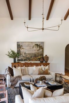 a living room filled with lots of white furniture