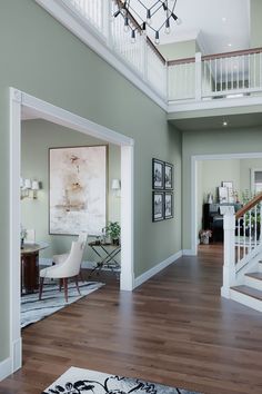 a living room filled with furniture and a staircase