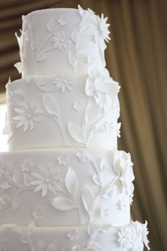 a white wedding cake with flowers on it