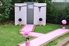 an outdoor party setup with pink flowers and decorations