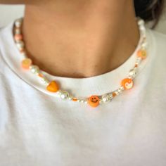 Click here for this cute and flirty choker/necklace. This adorable handmade orange necklace is everything you need to show your y2k aesthetic. This necklace includes an assortment of beads and is 16 inches in length and includes an extender to fit you perfectly.  If you think you need a little extra length, please let me know and I would be happy to make sure to give you enough length. White Beaded Y2k Style Jewelry, Handmade White Y2k Style Jewelry, Adjustable Orange Necklace For Summer, Orange Beaded Necklace For Summer, Cute Summer Festival Necklaces, Summer Orange Beaded Necklaces, Orange Necklace With Letter Beads For Gifts, Orange Beaded Choker Necklace For Festivals, Orange Beaded Choker For Festivals