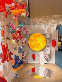 a room filled with lots of colorful glass items hanging from the ceiling and decorations on the walls