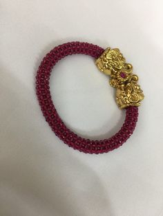 A new addition to our product line by our artisans. A beautiful piece for our traditional Indian Bride! Notice the gorgeous carving work on the twin elephant figure at the center and the red-colored beaded mesh at the base. Material: Brass and copper mix, gold plated, beads The bracelet is the same as shown in the picture and in the video. We have only one piece in this design and color and hence you get what you see in the picture. For wrist sizes 2.4- 2.6  Easily openable with a screw. Traditional Red Bracelets For Rituals, Traditional Red Bracelets With Zari Work, Traditional Red Bracelet With Zari Work, Festive Red Bracelets With Zari Work, Red Bracelets With Zari Work For Festive Season, Red Zari Work Bracelets For Festive Season, Red Zari Work Bracelet For Diwali, Red Bracelets With Intricate Design For Festive Occasion, Red Bracelet For Festive Rituals